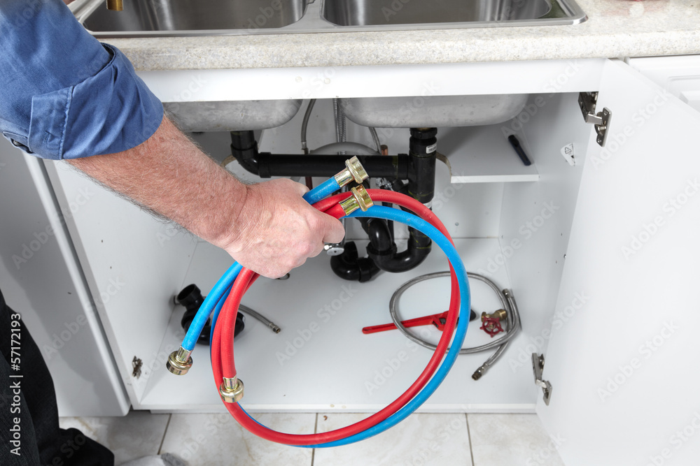 Hands of Plumber with a wrench. Hands of Plumber with a wrench.