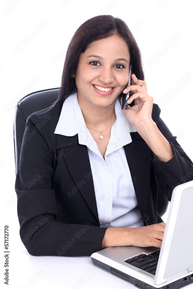 Happy young business woman talking on mobile phone Happy young business woman talking on mobile phone