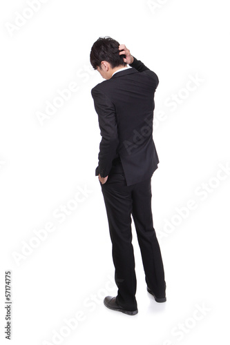 Rear view of young business man confused