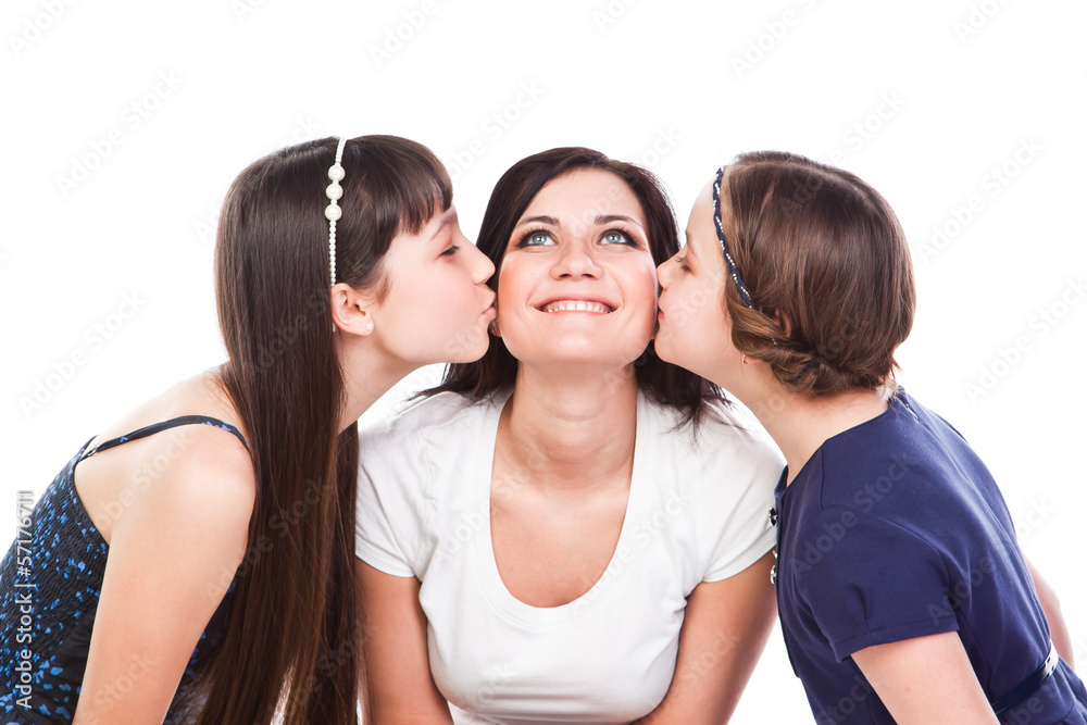 two beautiful daughters kiss their mother two beautiful daughters kiss their mother