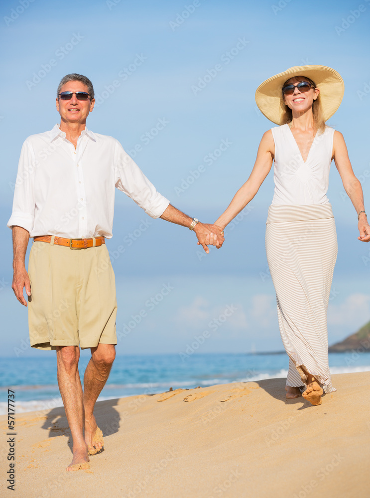 Middle Aged Couple Enjoying Walk on the Beach Middle Aged Couple Enjoying Walk on the Beach