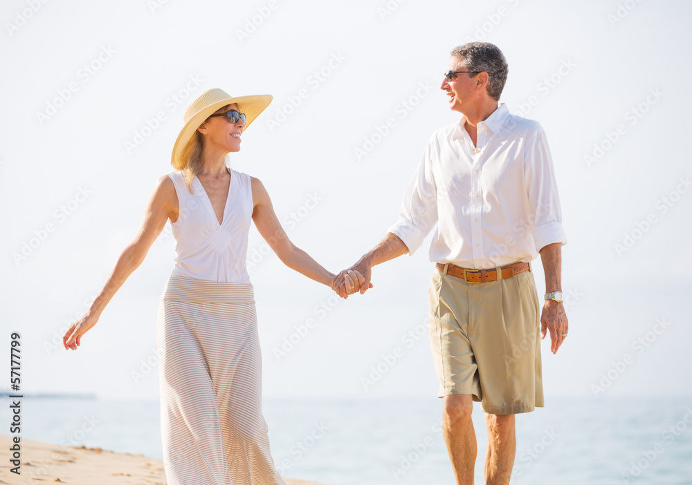 Middle Aged Couple Enjoying Walk on the Beach Middle Aged Couple Enjoying Walk on the Beach