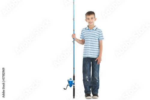 Smiling young boy holding fishing rod
