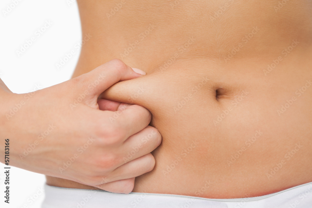 Young slim woman with little fat on her belly Young slim woman with little fat on her belly