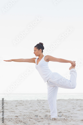 Woman in lord of the dance yoga pose