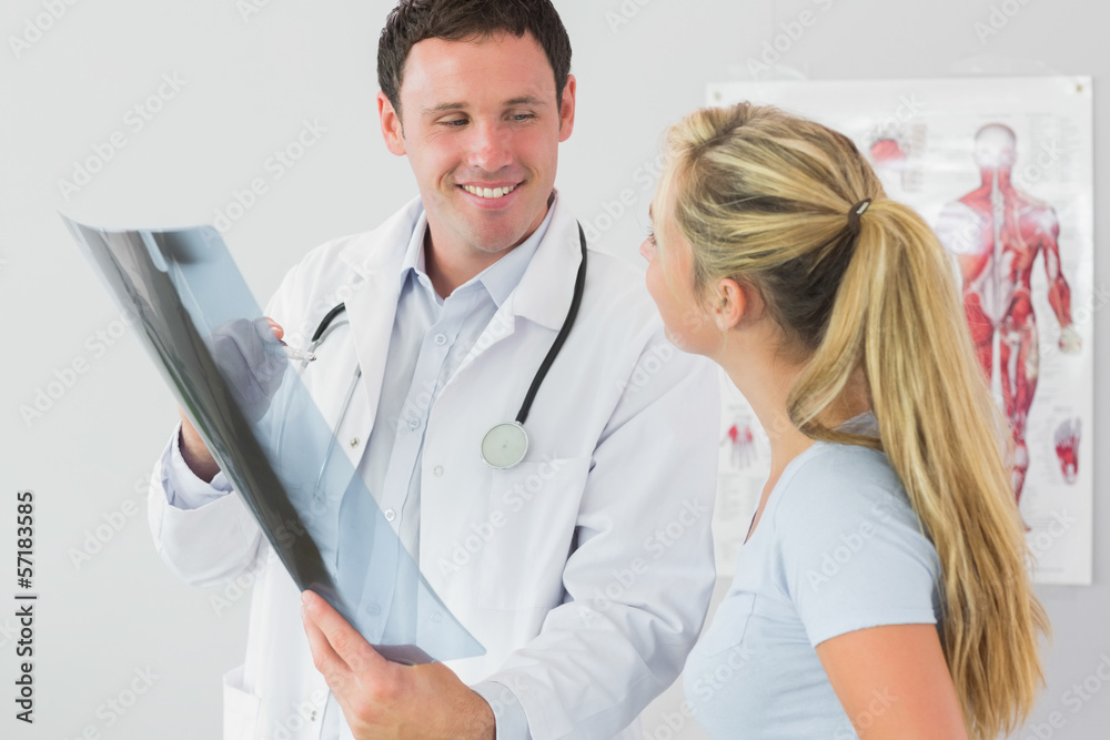 Cheerful doctor showing a patient something on x-ray Cheerful doctor showing a patient something on x-ray