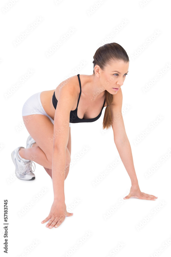 Serious woman in sportswear preparing for race Serious woman in sportswear preparing for race