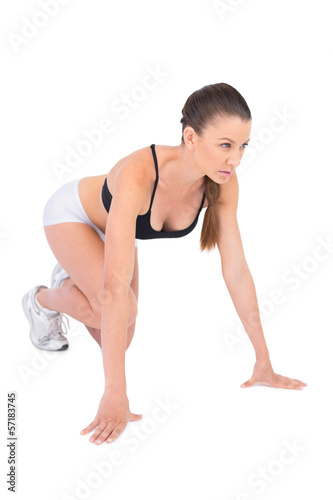 Serious woman in sportswear preparing for race