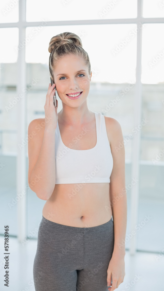 Cheerful sporty blonde on the phone