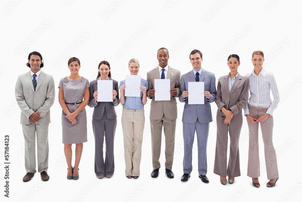 Happy business people holding four supports for letters Happy business people holding four supports for letters