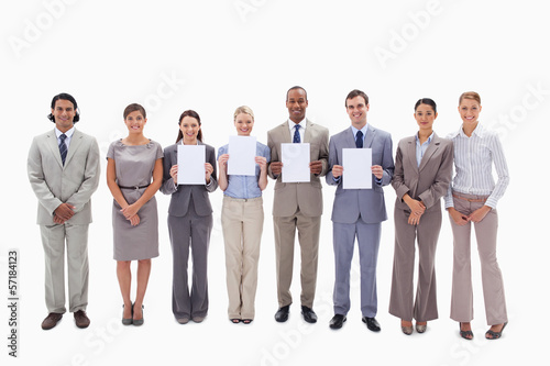 Happy business people holding four supports for letters