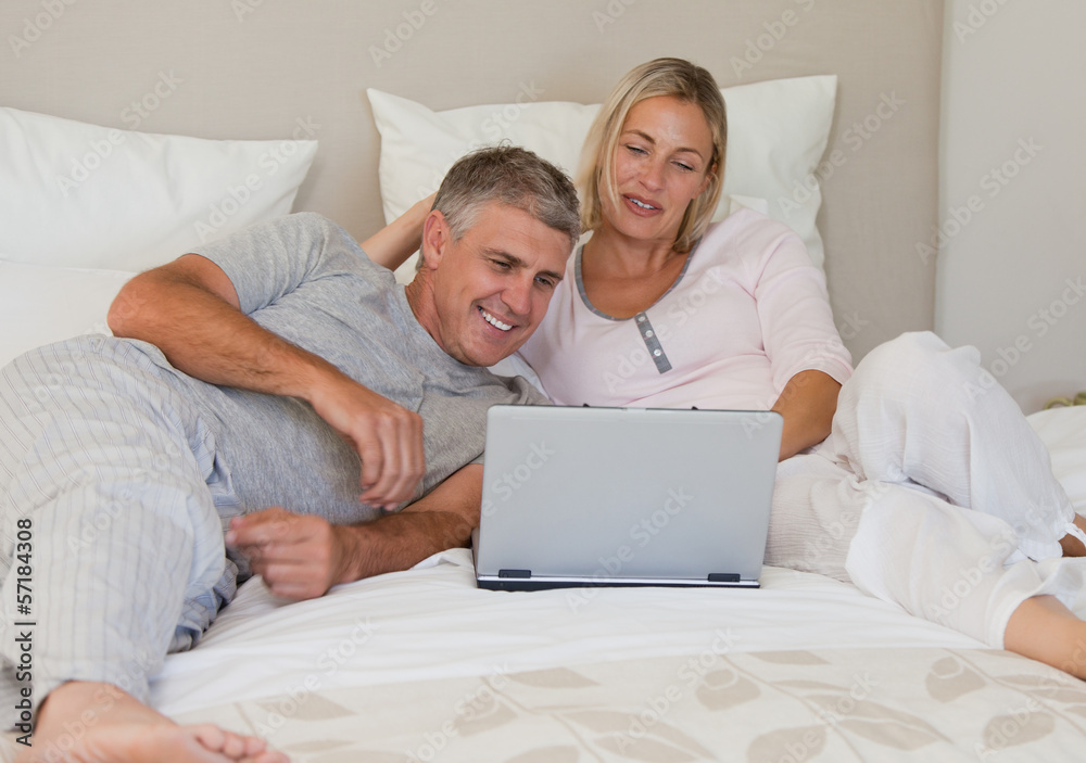Lovely couple looking at their laptop Lovely couple looking at their laptop