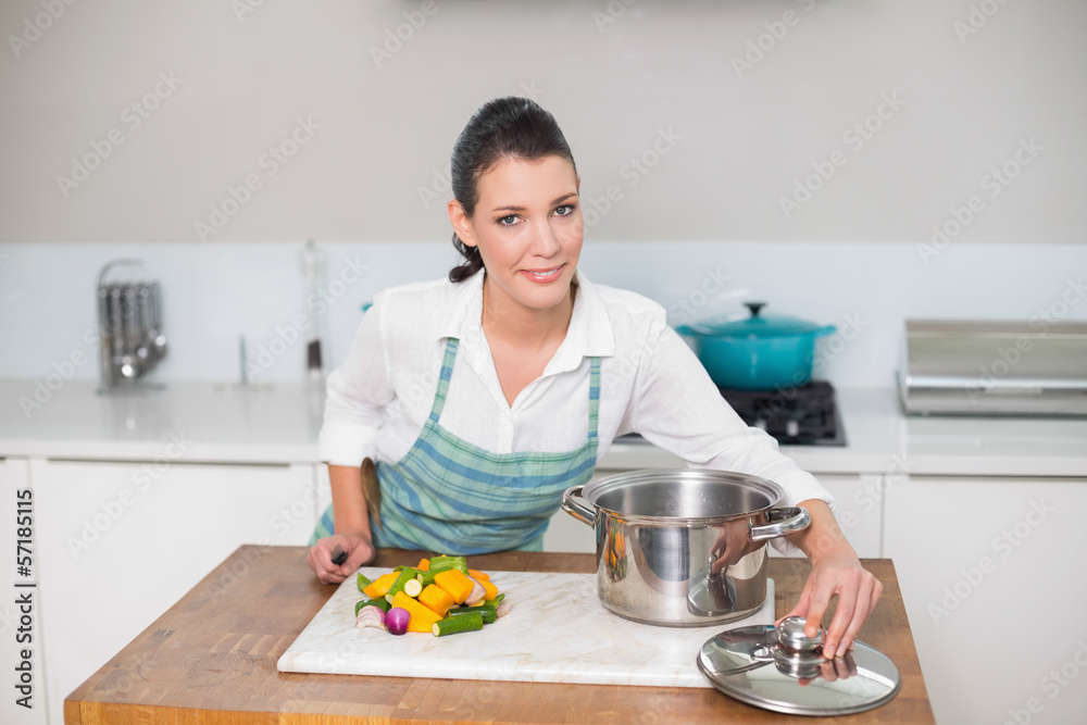 Content pretty woman wearing apron cooking