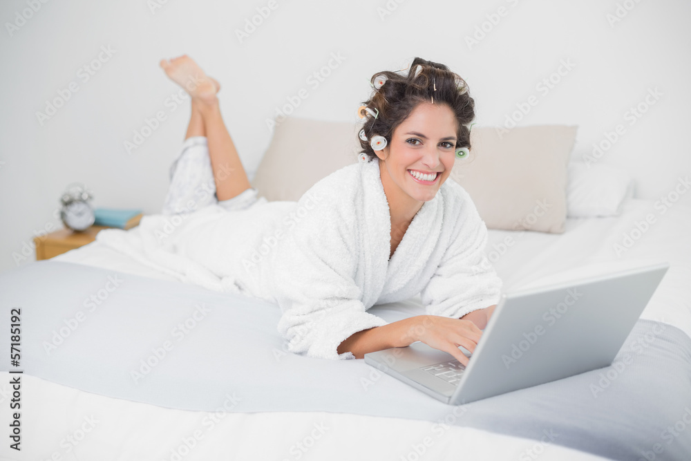 Smiling natural brunette using laptop Smiling natural brunette using laptop