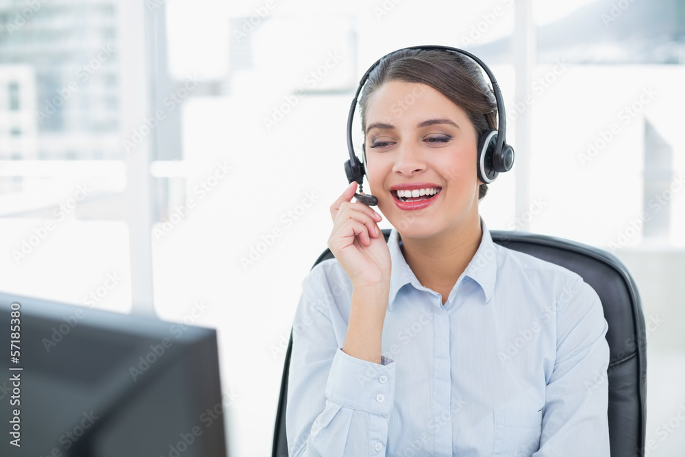 Attractive classy brown haired operator answering a call Attractive classy brown haired operator answering a call