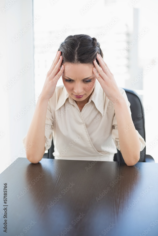 Nervous stylish brunette businesswoman holding her head Nervous stylish brunette businesswoman holding her head