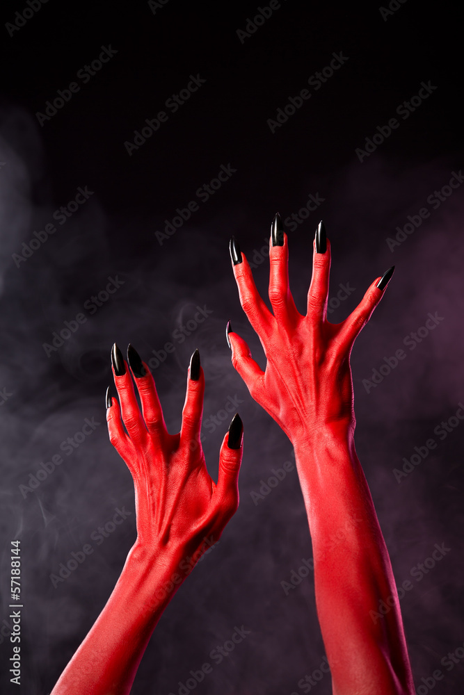 Red devil hands with black sharp nails, extreme body-art Red devil hands with black sharp nails, extreme body-art