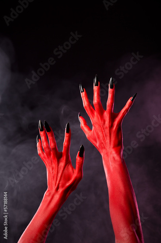 Red devil hands with black sharp nails  extreme body-art