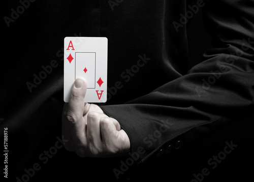 Businessman showing ace card behind his back photo