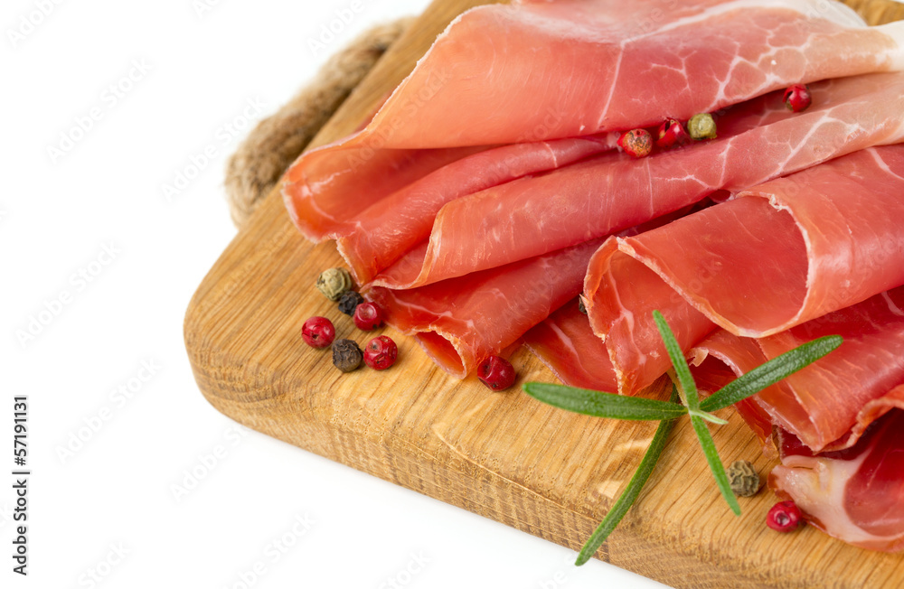sliced prosciutto on a wooden board sliced prosciutto on a wooden board