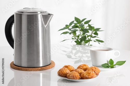Electric kettle, teacup and cookies