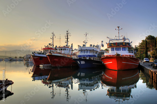Canvas-taulu Fishing boats on early morning on calm sea