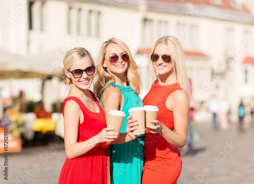 women with takeaway coffee cups in the city © Syda Productions