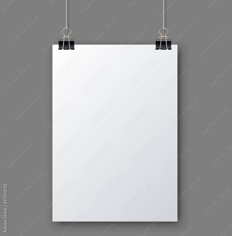 Blank white page hanging against grey wall