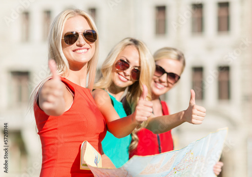 beautiful women with tourist map in the city