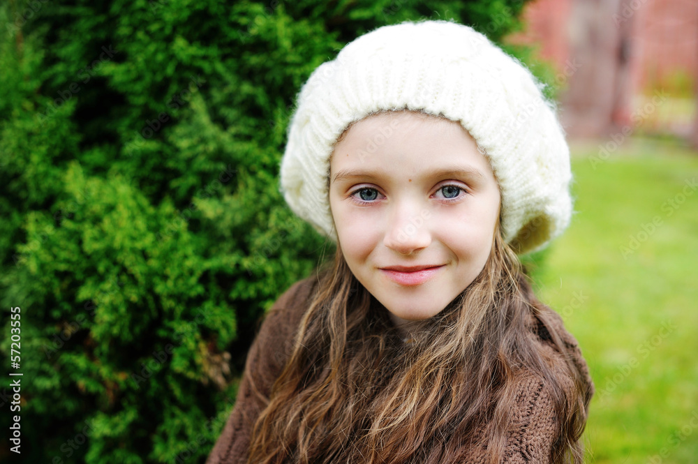 Child girl in white cap, close-up portrait