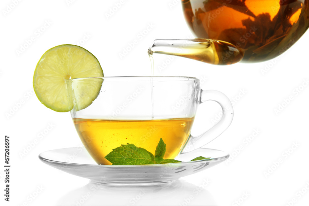 Pouring green tea into cup isolated on white Pouring green tea into cup isolated on white