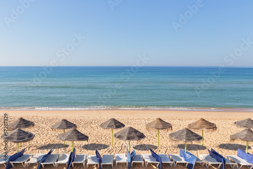 Exotic landscape with umbrellas on the beach near the beach. In