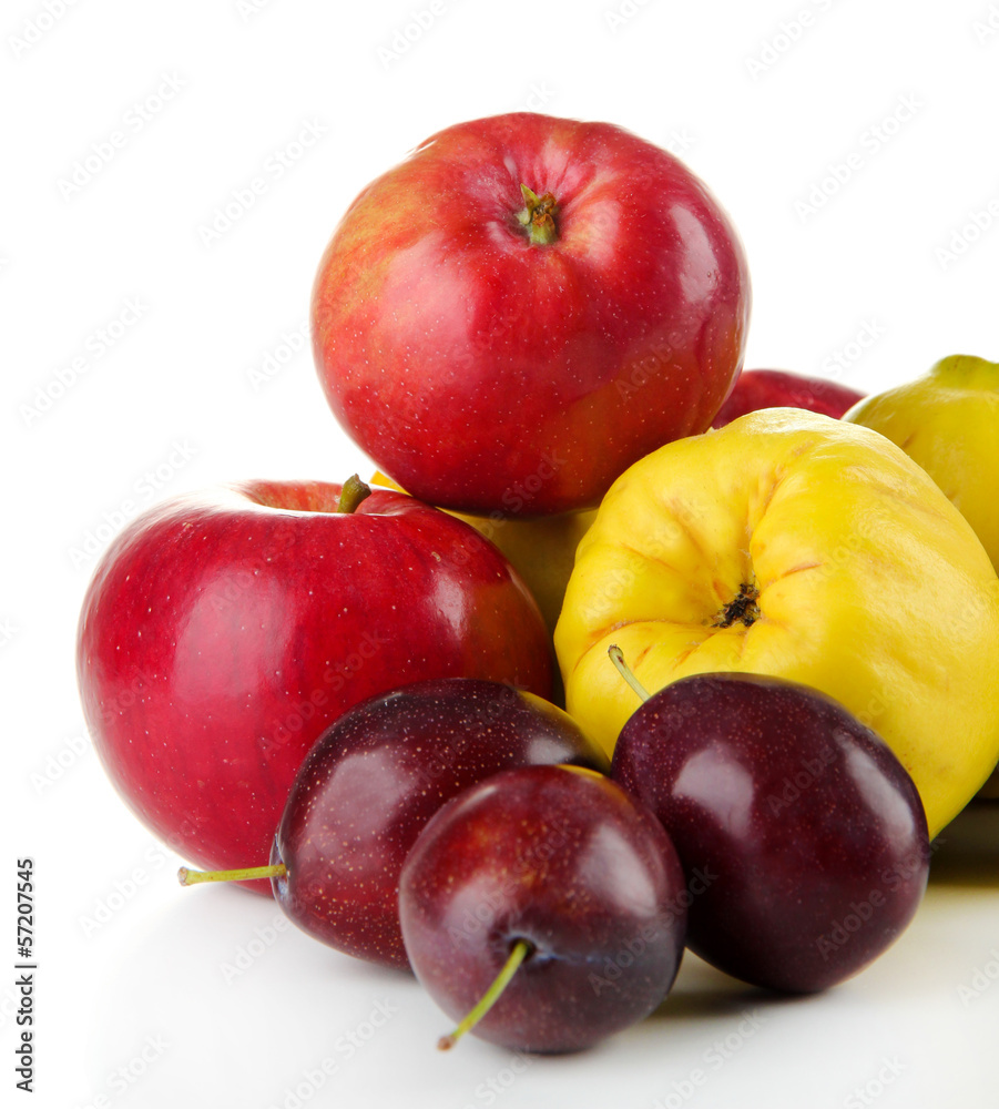 Quinces with apples and plums isolated on white