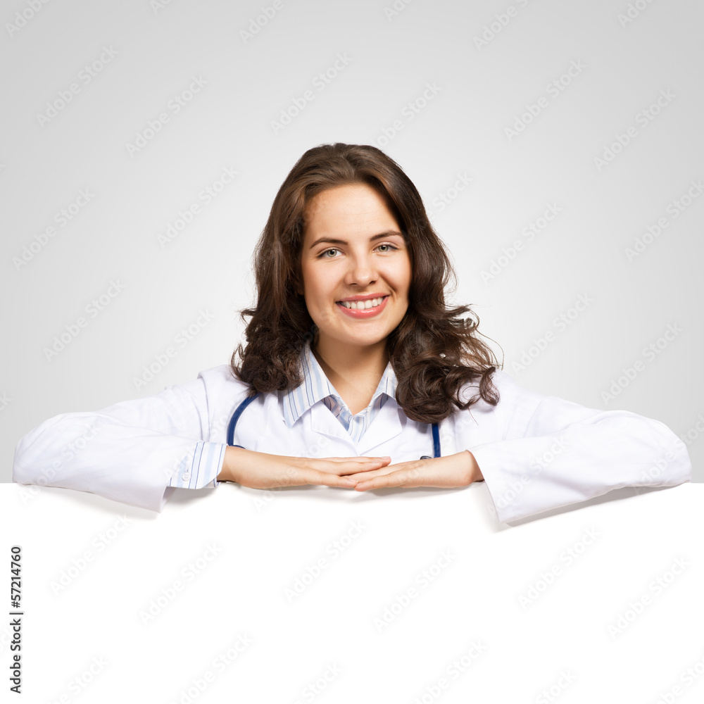 young woman doctor with a blank banner