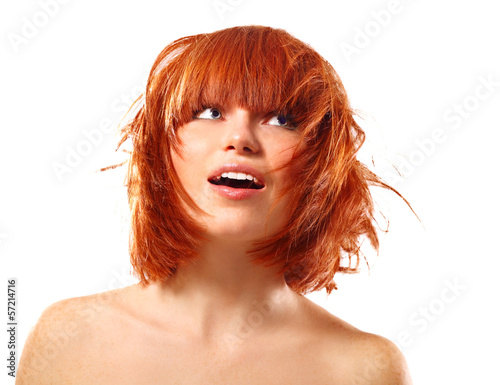 portrait of young beautiful redheaded woman looking up into the