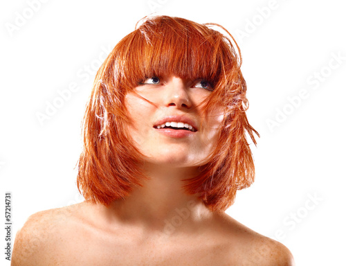portrait of young beautiful redheaded woman looking up into the