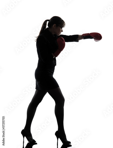 business woman punching boxing gloves silhouette