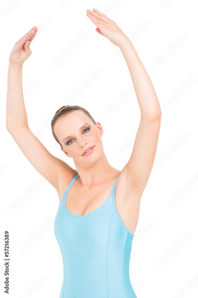 Smiling pretty ballerina posing with her arms raised Smiling pretty ballerina posing with her arms raised
