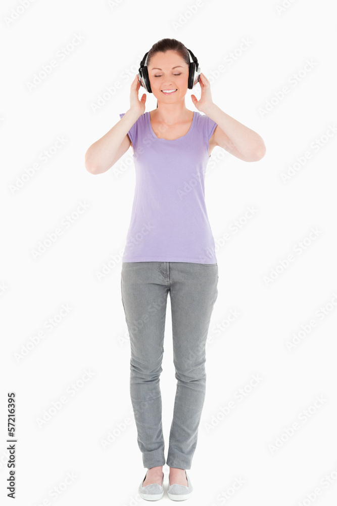 Beautiful woman posing with headphones while standing Beautiful woman posing with headphones while standing