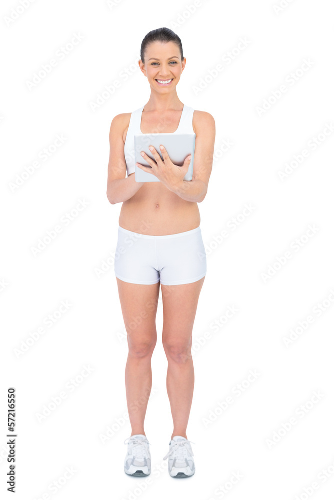 Cheerful fit woman using tablet computer Cheerful fit woman using tablet computer