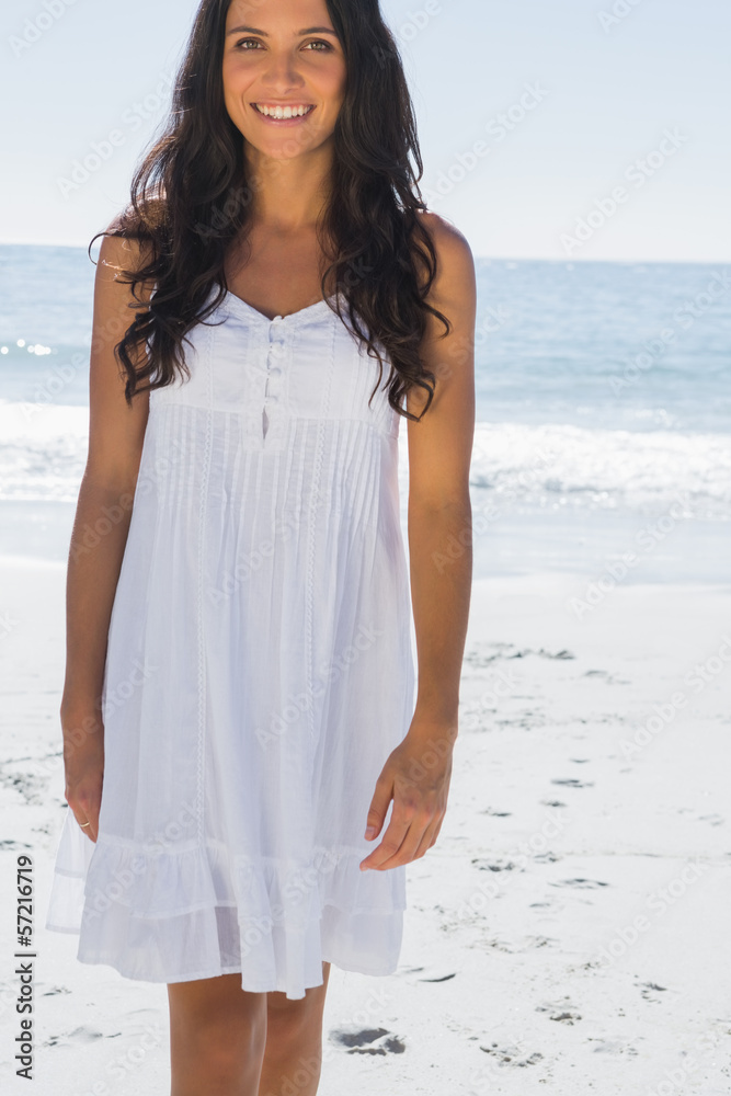 Happy brunette in white sun dress walking towards camera Stock Photo ...