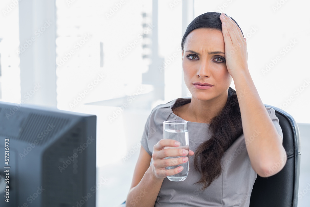 Attractive secretary with headache touching her head Attractive secretary with headache touching her head