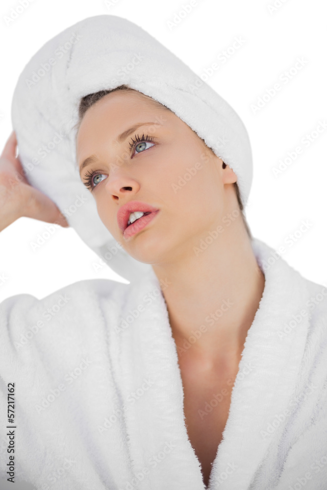 Contemplative brunette in bathrobe looking away Contemplative brunette in bathrobe looking away