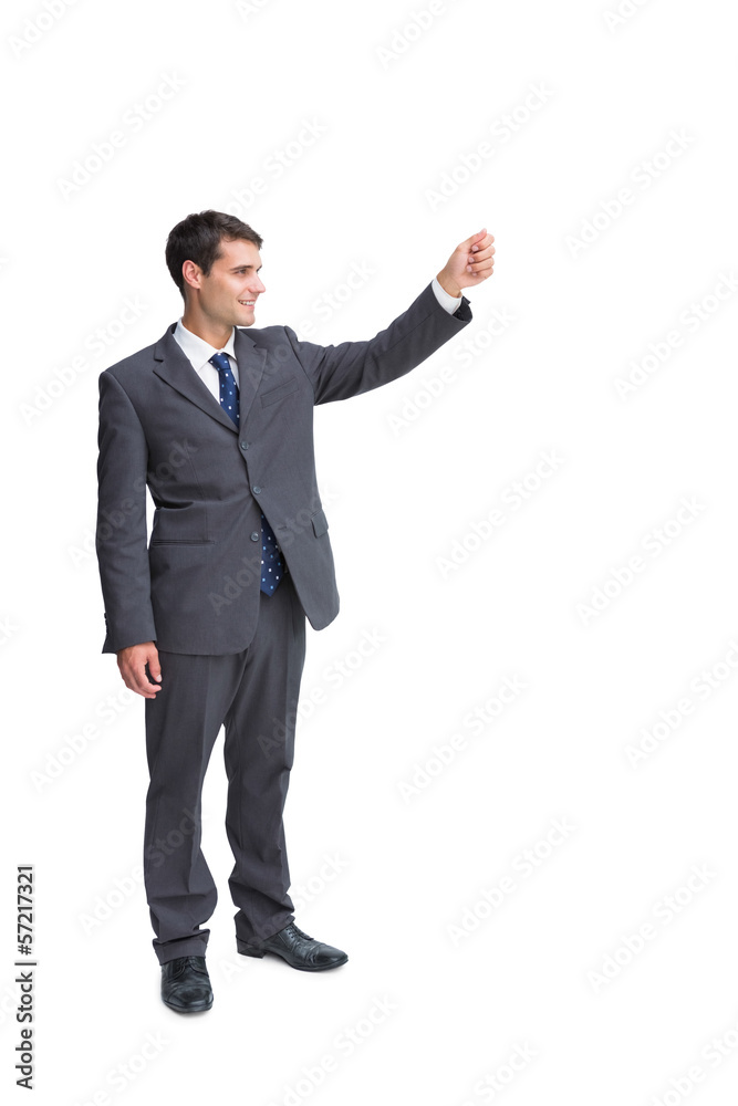 Smiling businessman holding something up in the air Smiling businessman holding something up in the air
