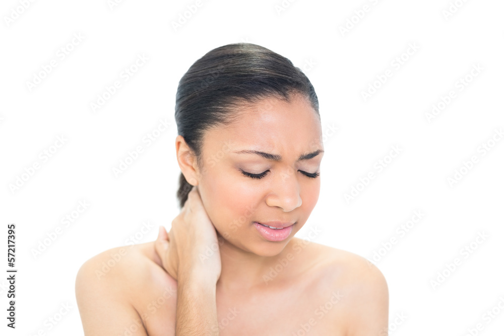 Anxious young dark haired model suffering from neck ache Anxious young dark haired model suffering from neck ache