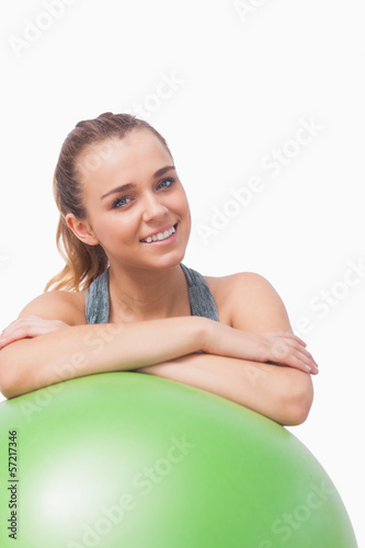 Cheerful young woman supporting herself with a fitness ball © WavebreakMediaMicro