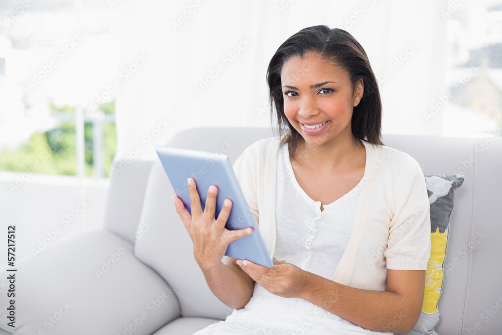 Pleased young dark haired woman in white clothes using a a table Pleased young dark haired woman in white clothes using a a table