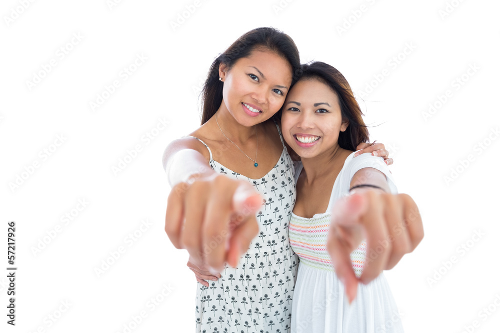 Two beautiful young women pointing at the camera Two beautiful young women pointing at the camera