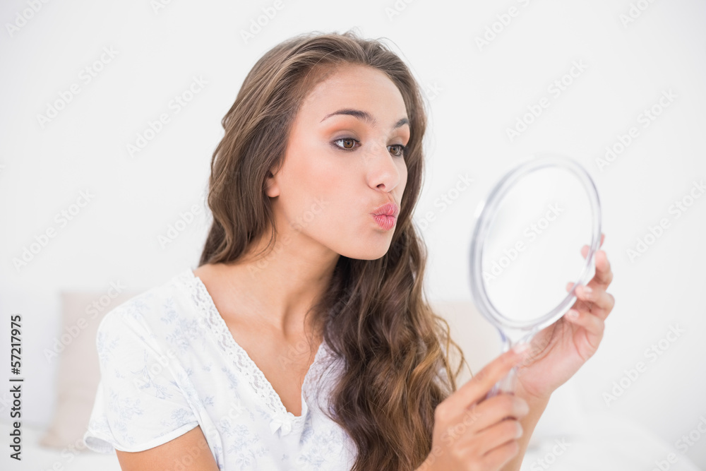 Attractive brunette posing in front of mirror Attractive brunette posing in front of mirror