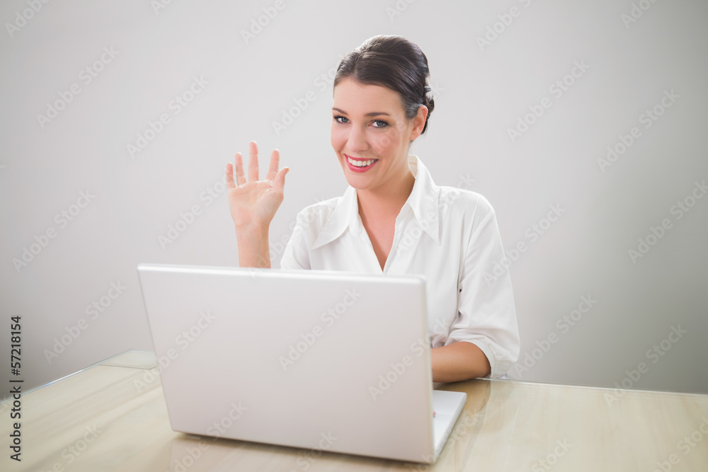 Waving gorgeous businesswoman using laptop Waving gorgeous businesswoman using laptop